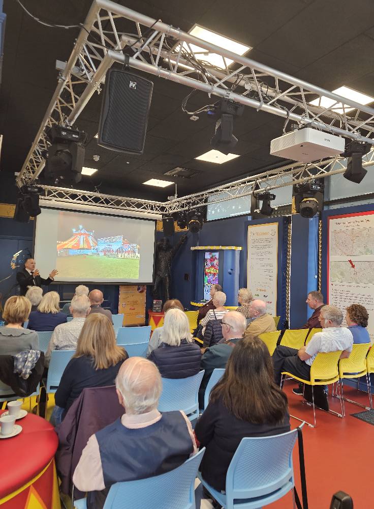 Lecturer performer Andrew Van Buren speaking about circus buildings. 